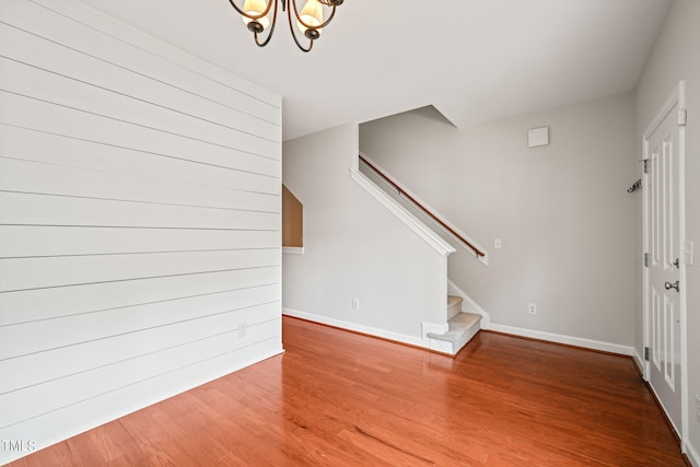 interior space with a chandelier and hardwood / wood-style flooring