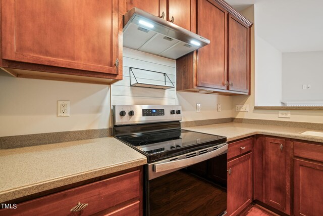 kitchen featuring wood-type flooring, extractor fan, and electric stove