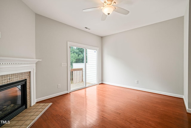 unfurnished living room with ceiling fan, a fireplace, and hardwood / wood-style floors