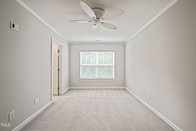 carpeted spare room with ceiling fan and ornamental molding