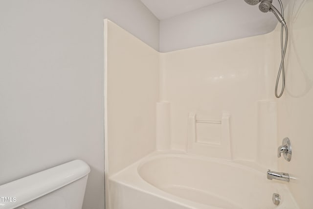 bathroom featuring tub / shower combination and toilet