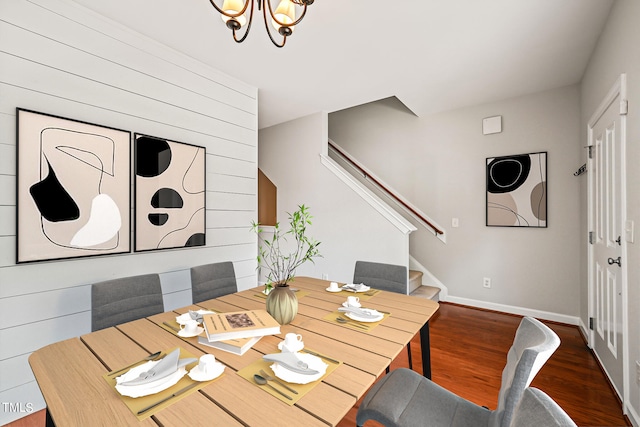 dining space with an inviting chandelier and dark wood-type flooring