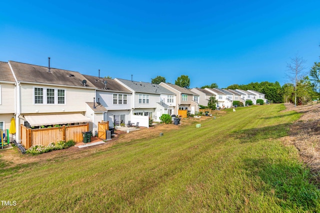 rear view of property featuring a yard and a garage