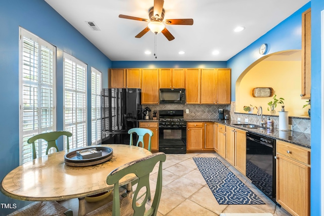 kitchen with black appliances, a wealth of natural light, sink, and ceiling fan