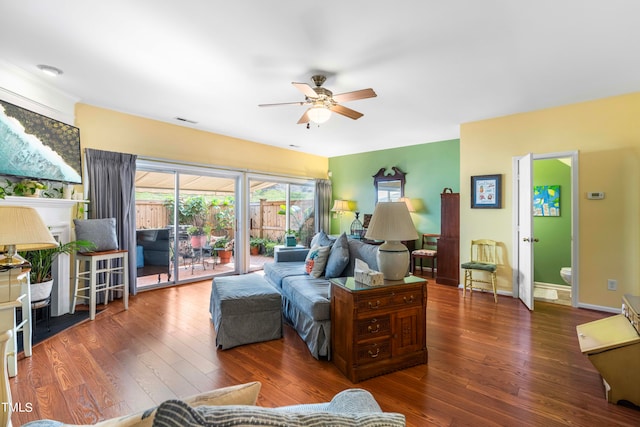 living room with dark wood-type flooring and ceiling fan