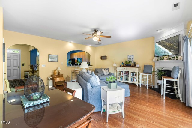 living room featuring ceiling fan and hardwood / wood-style floors