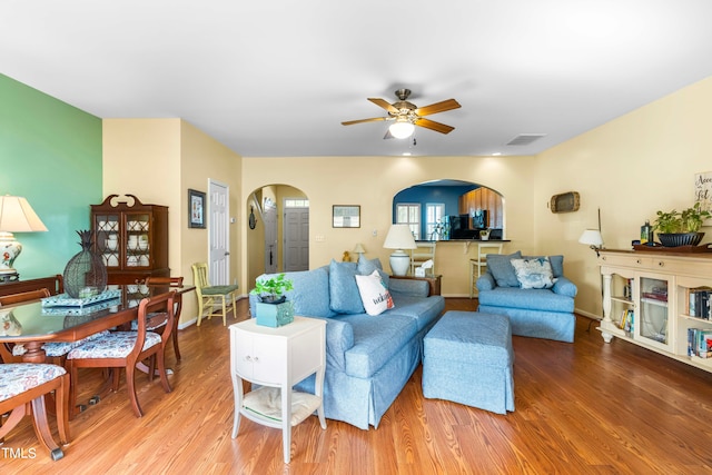 living room with ceiling fan and hardwood / wood-style flooring