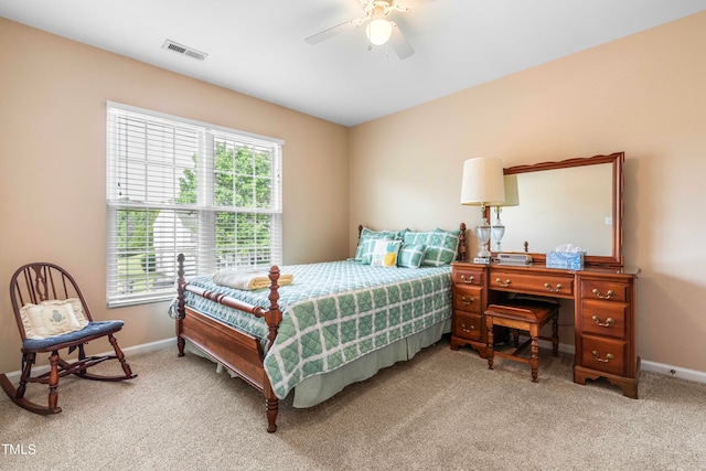 carpeted bedroom with multiple windows and ceiling fan