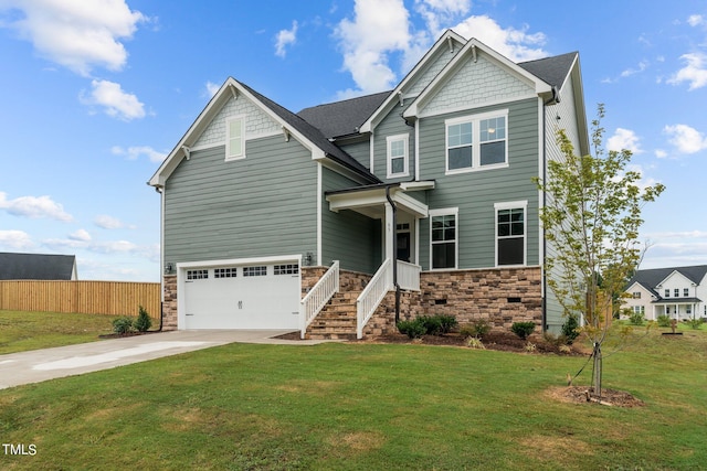 craftsman house with a garage and a front lawn