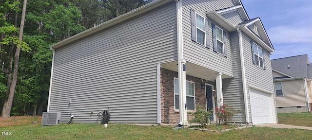 view of home's exterior with a yard, central AC unit, and stone siding