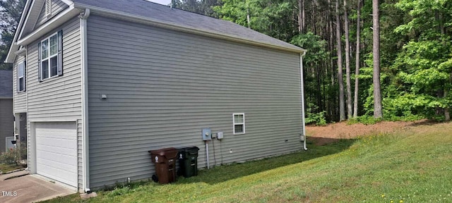 view of property exterior with a garage and a yard