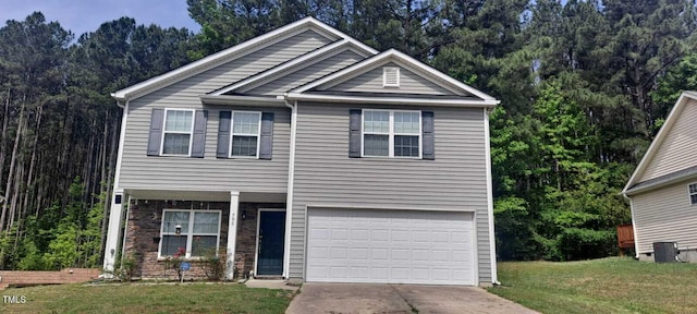 view of front of home with an attached garage, a front yard, a view of trees, stone siding, and driveway