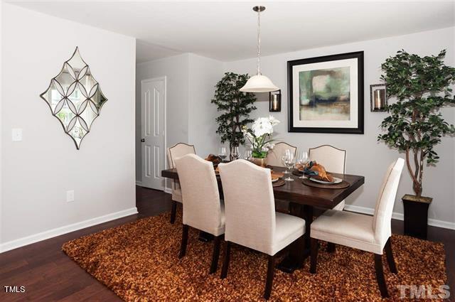 dining space with dark wood-type flooring