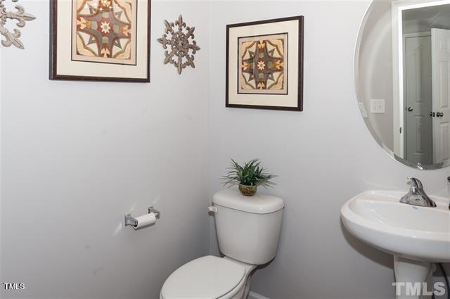 half bathroom featuring toilet and a sink