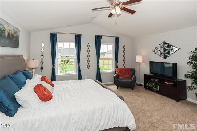 bedroom featuring baseboards, carpet, a ceiling fan, and vaulted ceiling