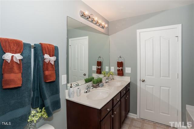 full bath with double vanity and a sink