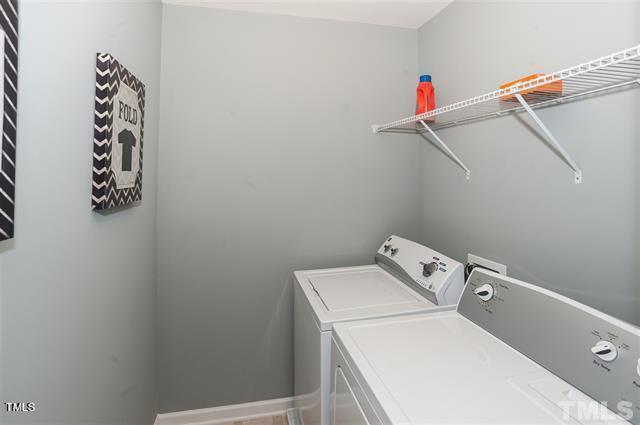 washroom with washing machine and clothes dryer