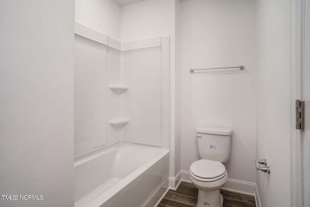 bathroom with shower / bath combination, toilet, and hardwood / wood-style flooring