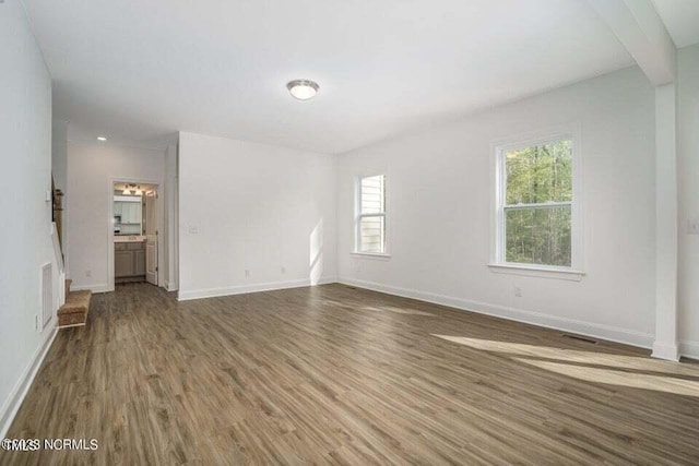 unfurnished living room with hardwood / wood-style floors and a wealth of natural light