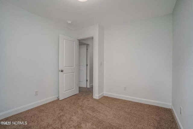 unfurnished bedroom with light colored carpet