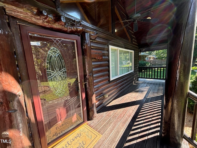 entrance to property featuring ceiling fan and covered porch