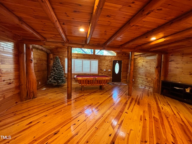 interior space with wood ceiling, light hardwood / wood-style floors, wood walls, and beamed ceiling