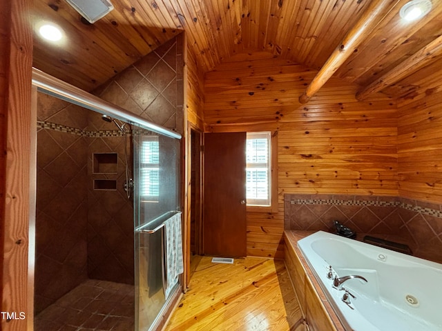 bathroom featuring plus walk in shower, lofted ceiling, and wood walls