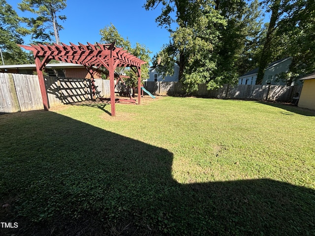 view of yard featuring a playground and a pergola