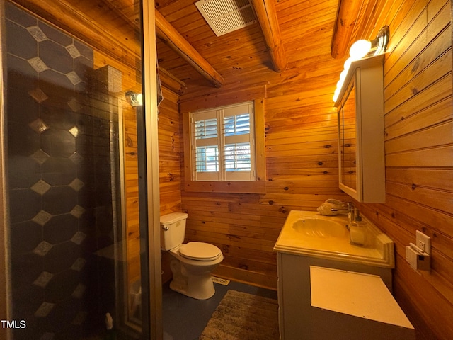 bathroom featuring wooden walls, beam ceiling, vanity, and toilet