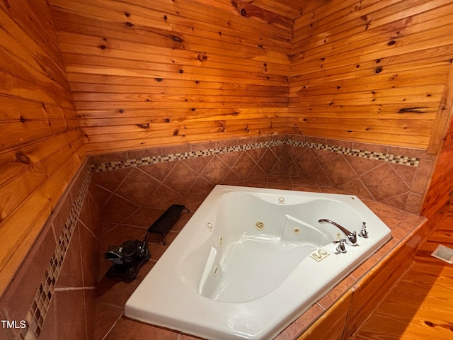 bathroom featuring wooden walls, a bathing tub, and wood-type flooring