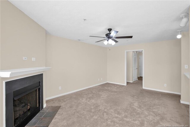 unfurnished living room featuring ceiling fan and carpet flooring