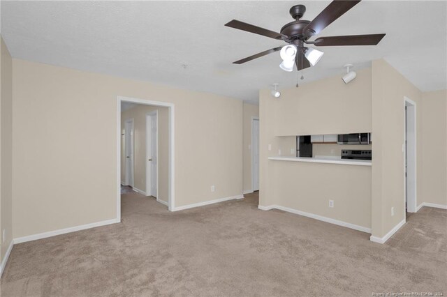 unfurnished living room with light colored carpet and ceiling fan