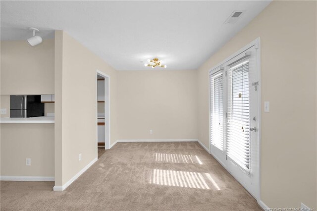 unfurnished room with plenty of natural light and light colored carpet