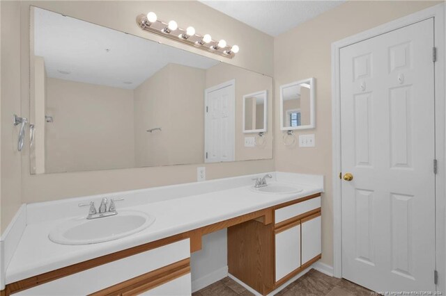 bathroom featuring tile patterned flooring and vanity