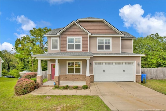 craftsman house featuring a garage, a front lawn, and covered porch