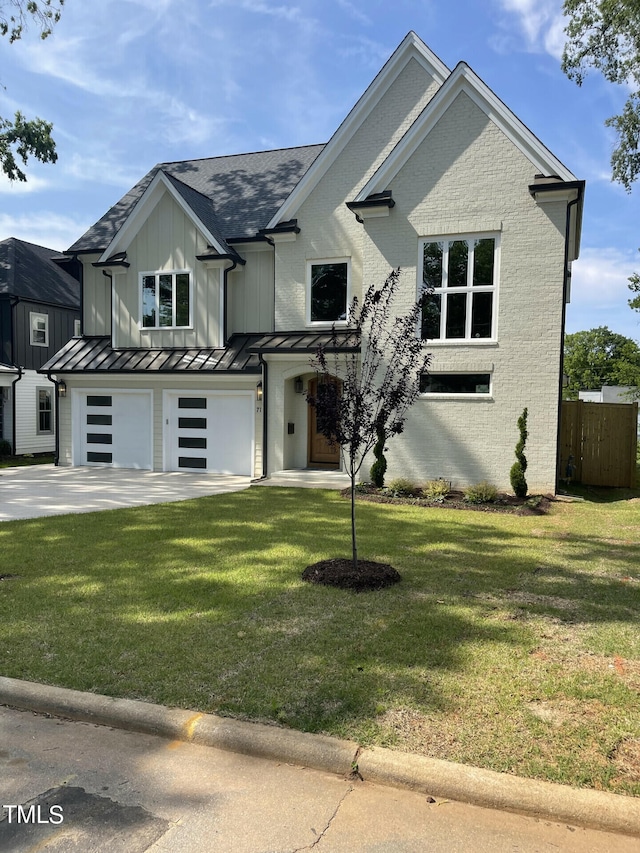 view of front of property featuring a garage and a front lawn