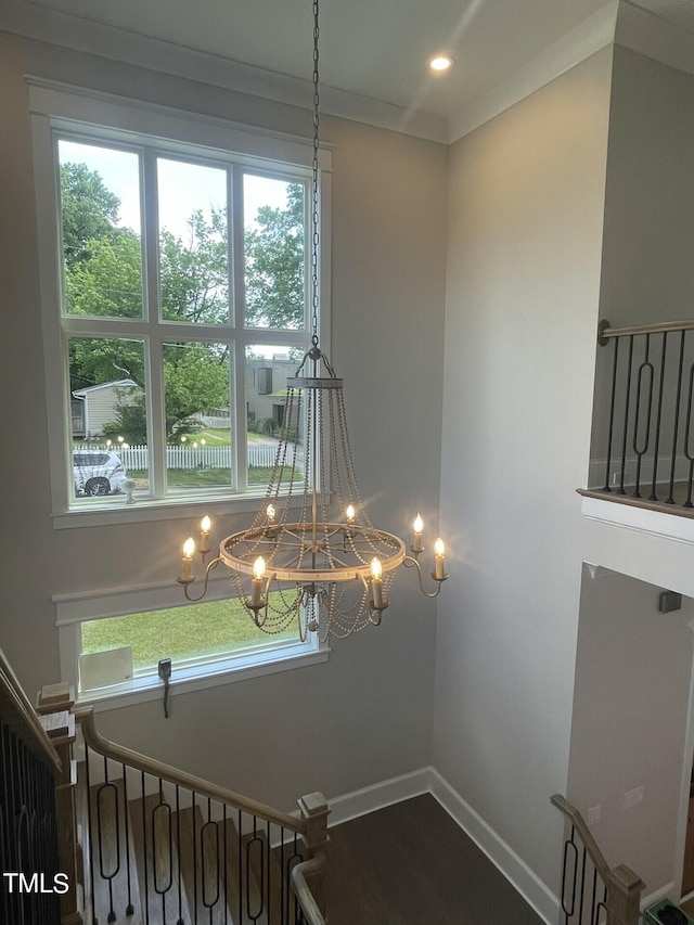 room details featuring ornamental molding and a chandelier