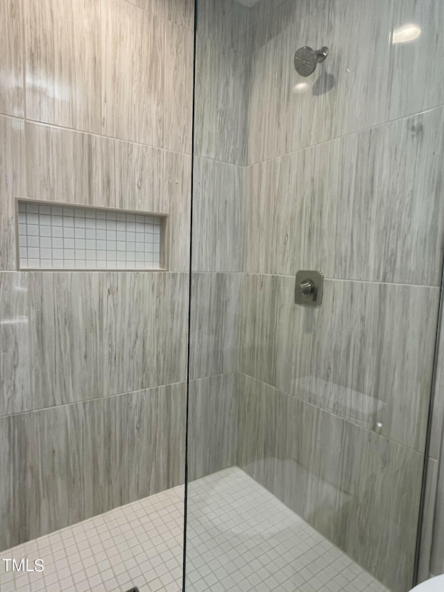 bathroom with tiled shower