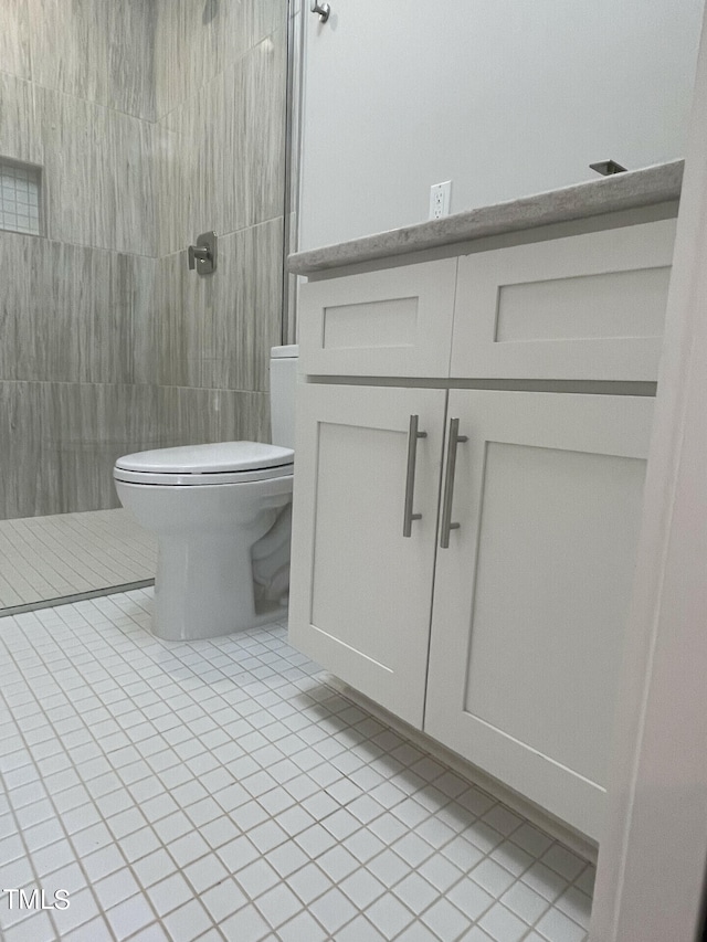 bathroom featuring tile walls, toilet, and vanity