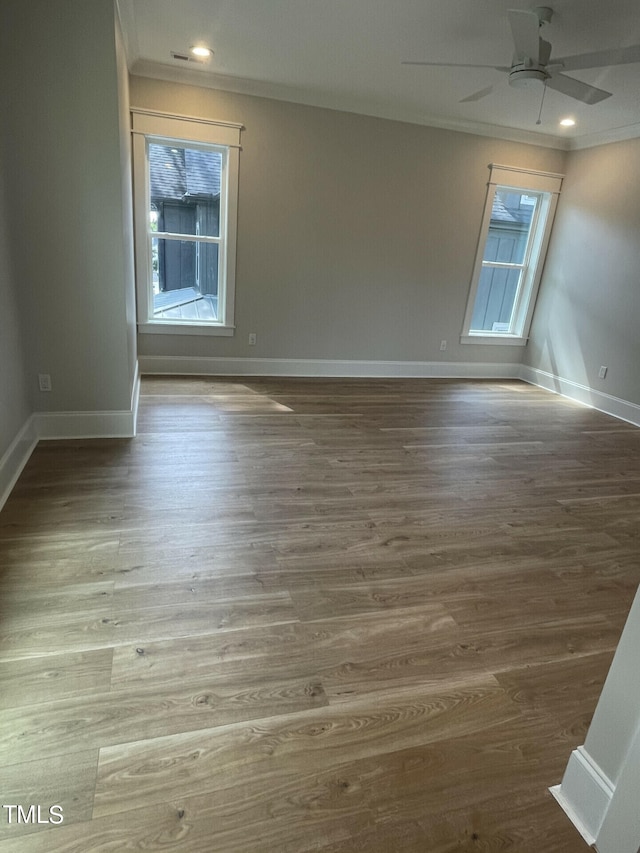 unfurnished room with dark wood-type flooring, ceiling fan, and ornamental molding