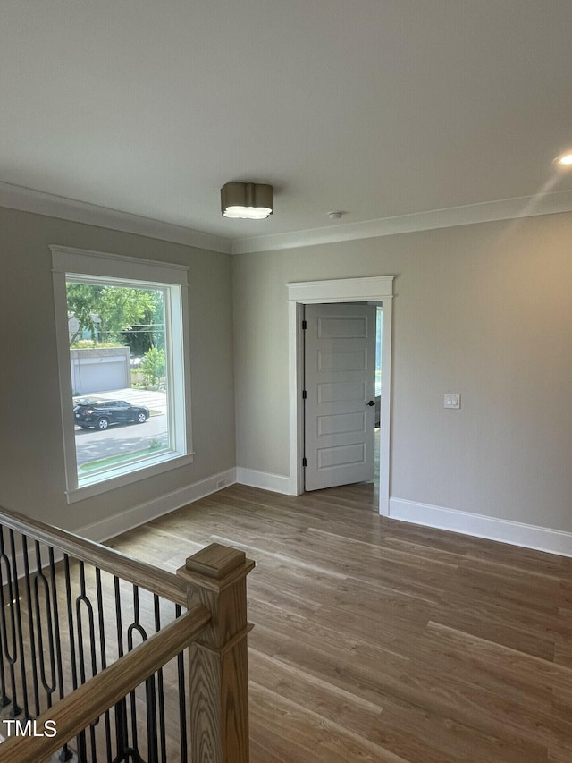 unfurnished room featuring ornamental molding and hardwood / wood-style floors