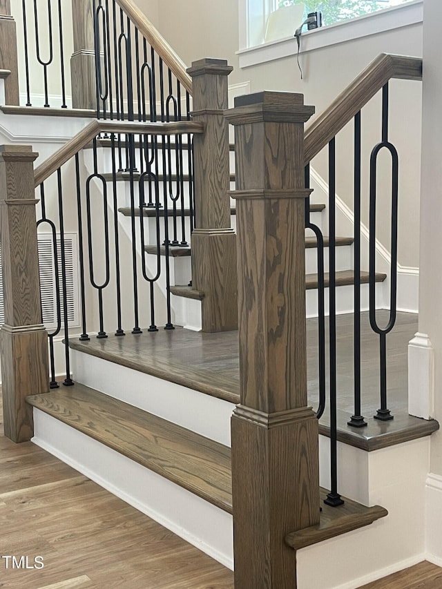 staircase featuring hardwood / wood-style flooring