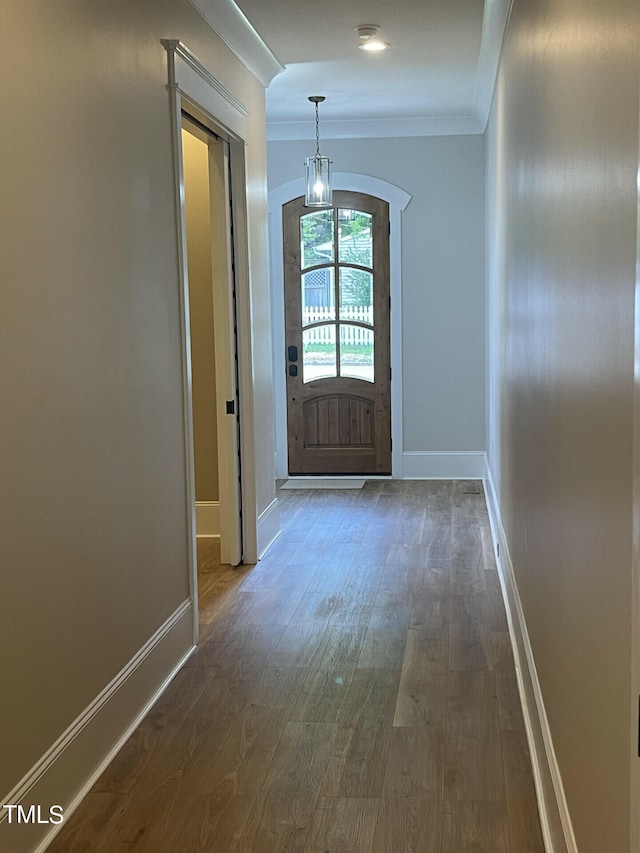 entryway with dark hardwood / wood-style floors and crown molding