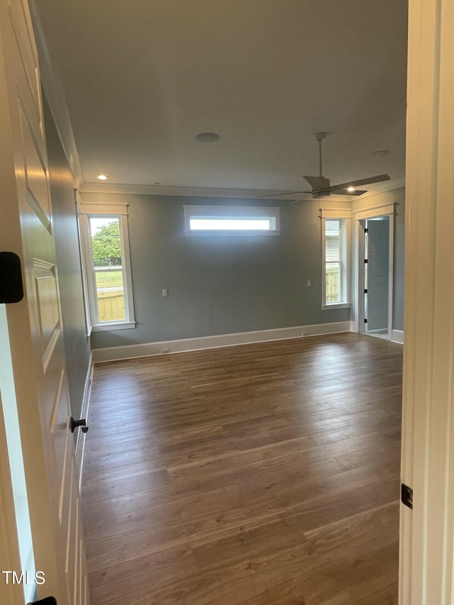 empty room with dark hardwood / wood-style flooring and ceiling fan