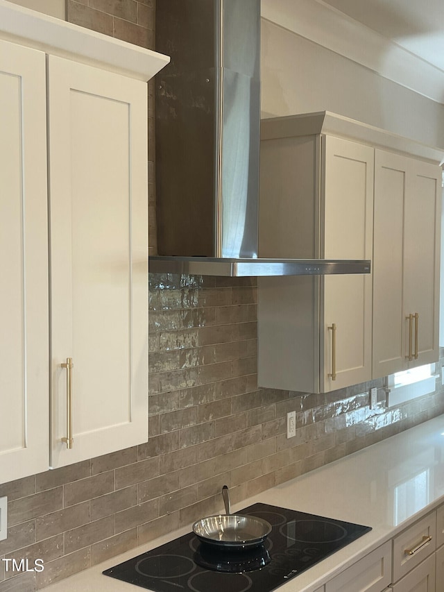 kitchen featuring black electric stovetop and white cabinets