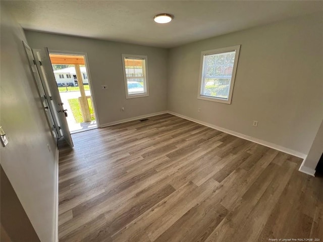 spare room with hardwood / wood-style floors