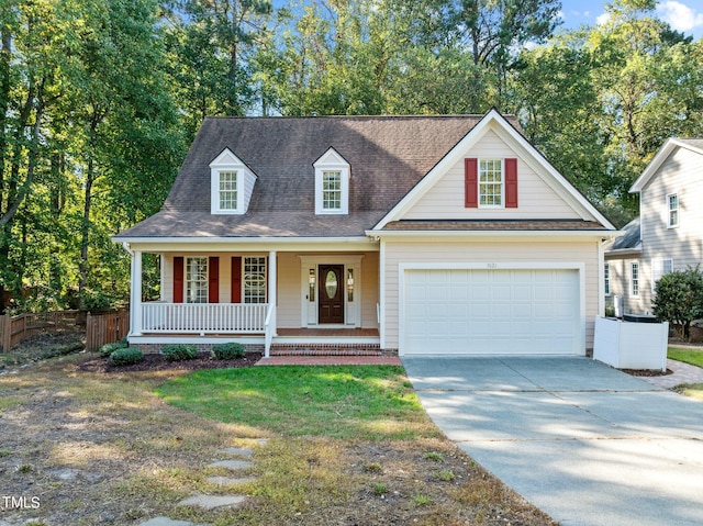 view of front of home featuring a front yard, covered porch, and a garage