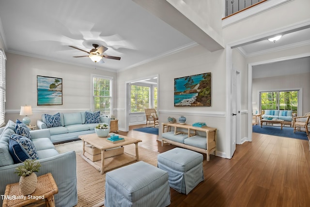 living room featuring ceiling fan, hardwood / wood-style flooring, and ornamental molding