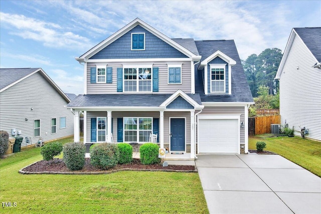 view of front of property featuring central AC, a front yard, and a garage