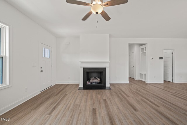 unfurnished living room featuring ceiling fan and light hardwood / wood-style floors